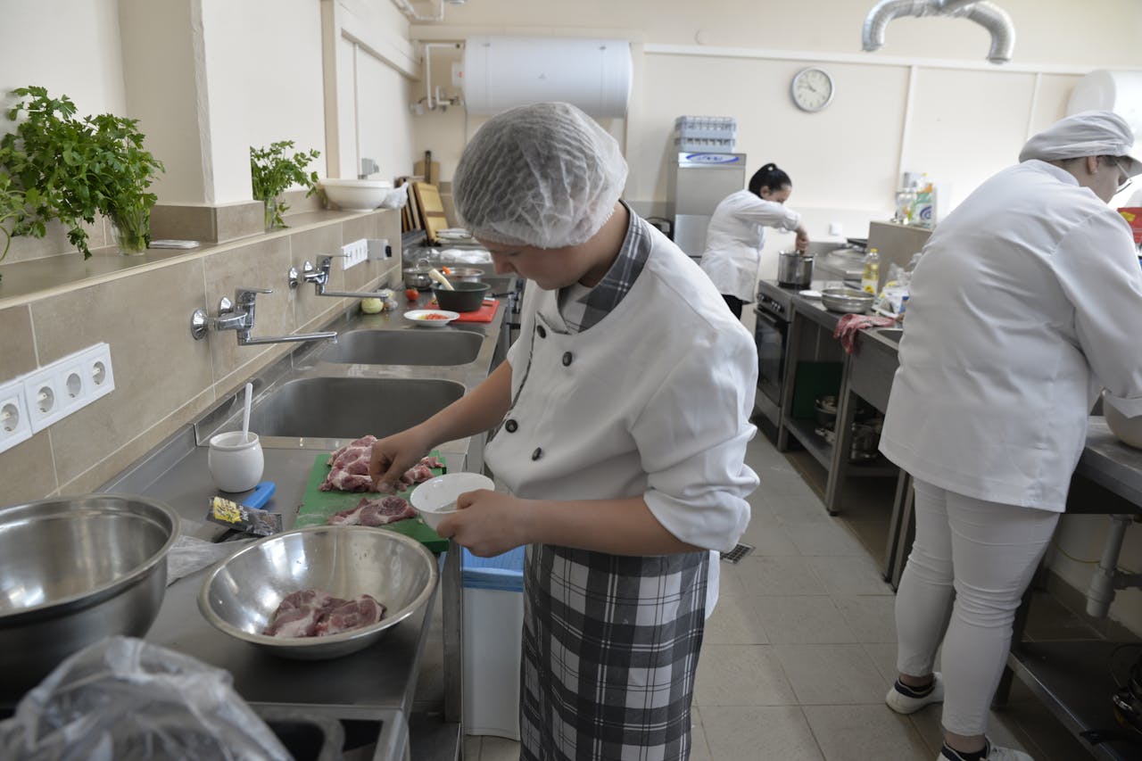 Crafting Captivating Headlines: Your awesome post title goes here Culinary students practicing cooking skills in a professional kitchen setting, showcasing teamwork and education.